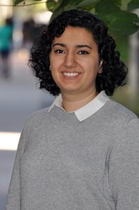 Portrait of Fatomeh standing outside on academic row on the campus of UMBC.