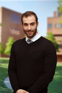 A three quarter portrait of Adnan on the Library green.