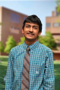 A three quarter portrait of Adursh on the Library green.