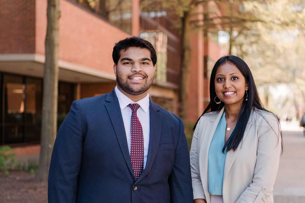 Two students posing for a picture on academic row