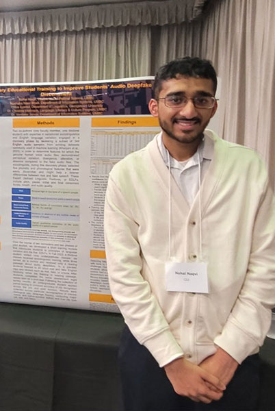 A young student standing in front of his poster during a research presentation event